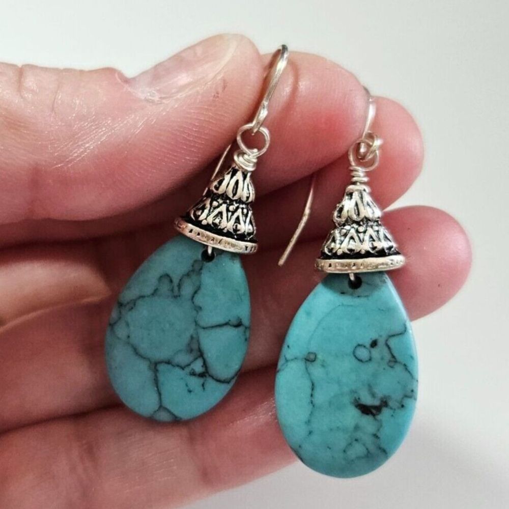 Silver tone teardrop shaped turquoise dangling earrings